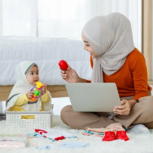 A woman and baby playing with toys on the floor