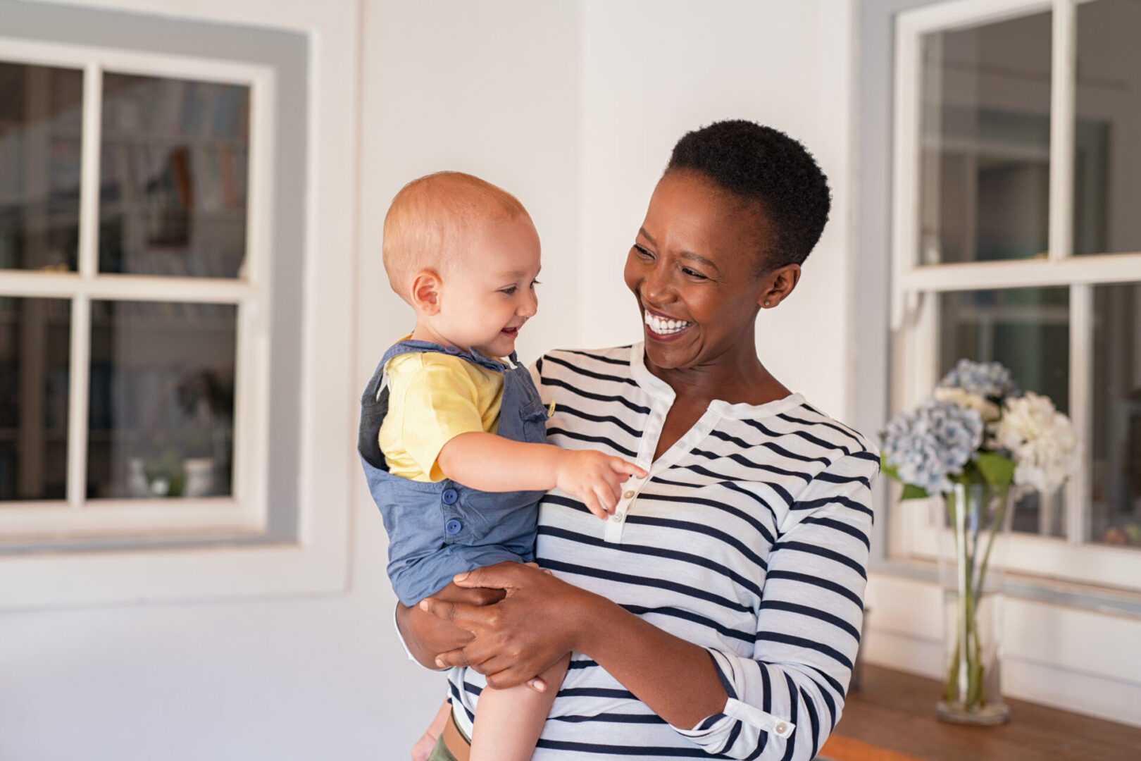 A woman holding a baby in her arms.