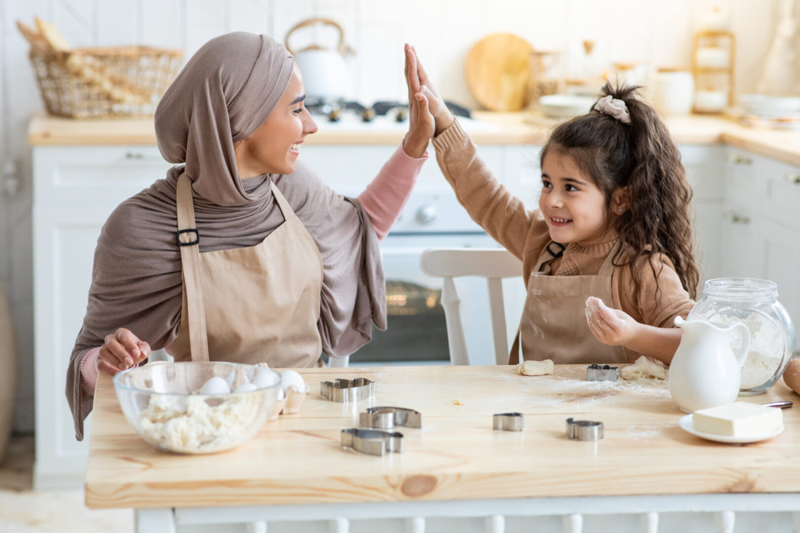 A woman and child giving each other high five.