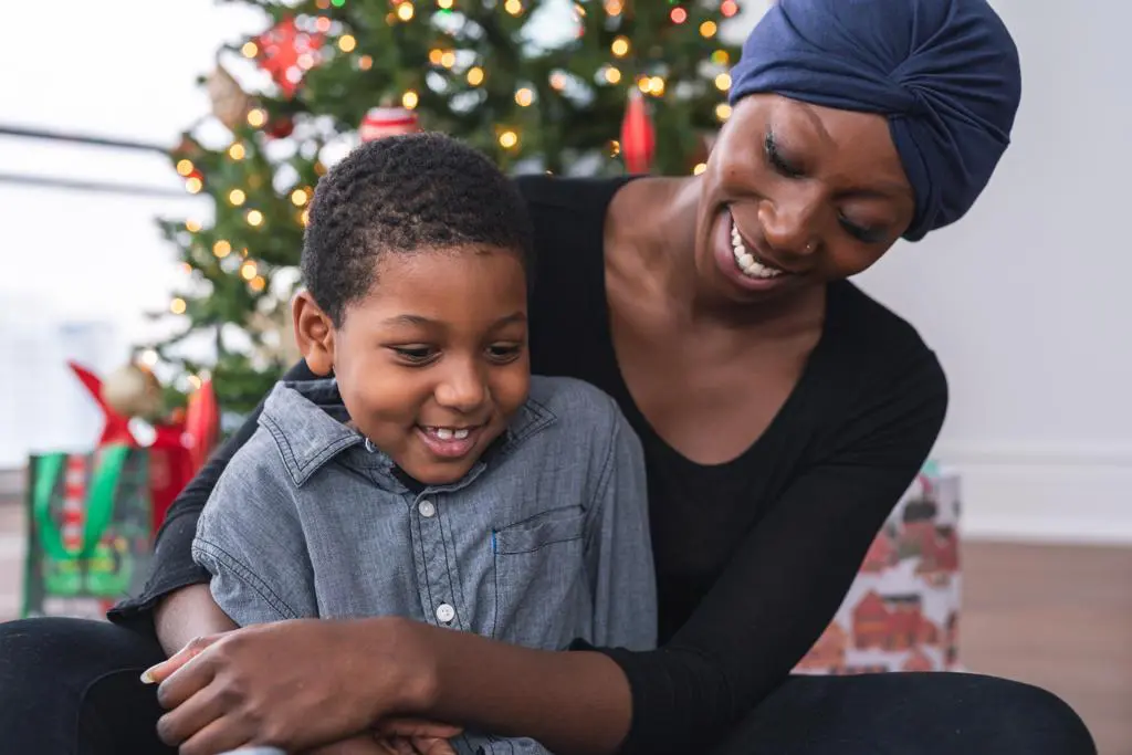 A woman and child smiling for the camera.