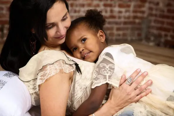 A woman holding a child in her arms.