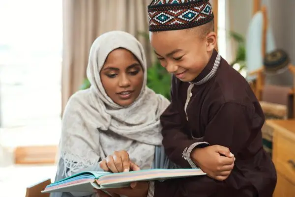 A woman and child reading a book together.