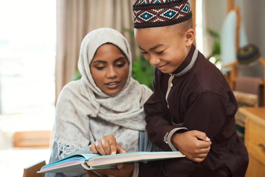 A woman and child reading a book together.