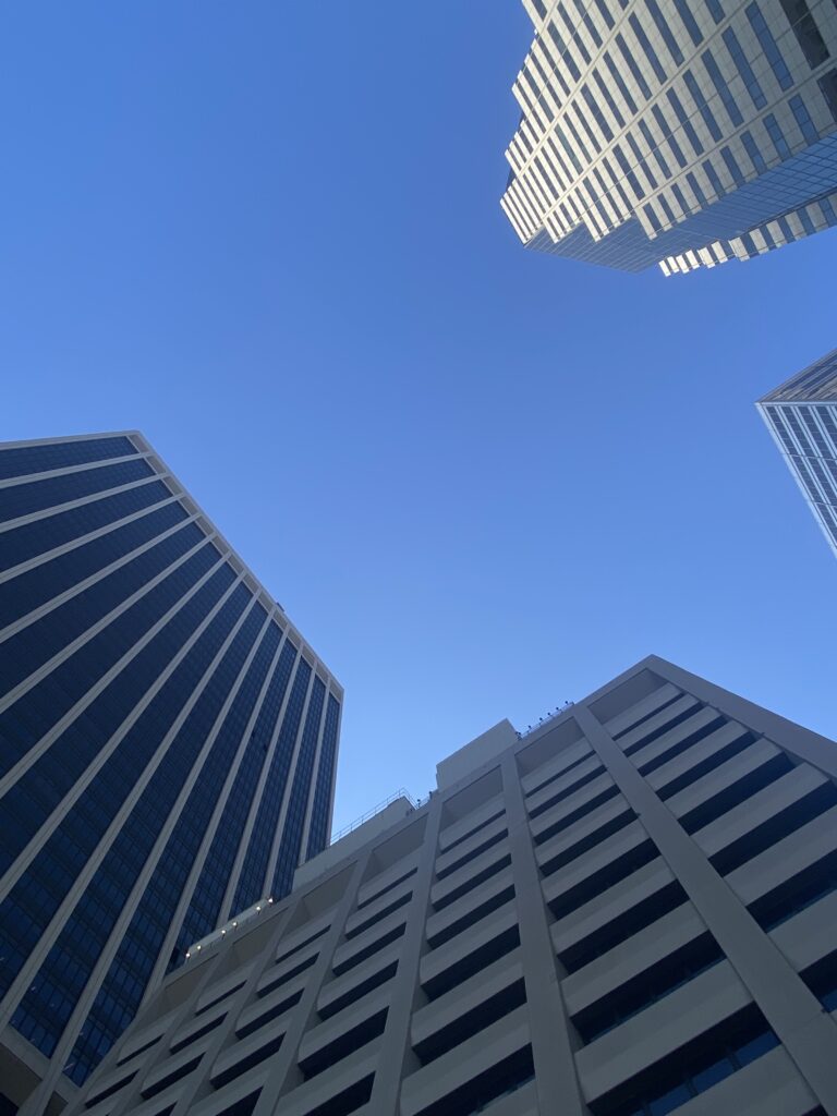 A view of some skyscrapers from below.