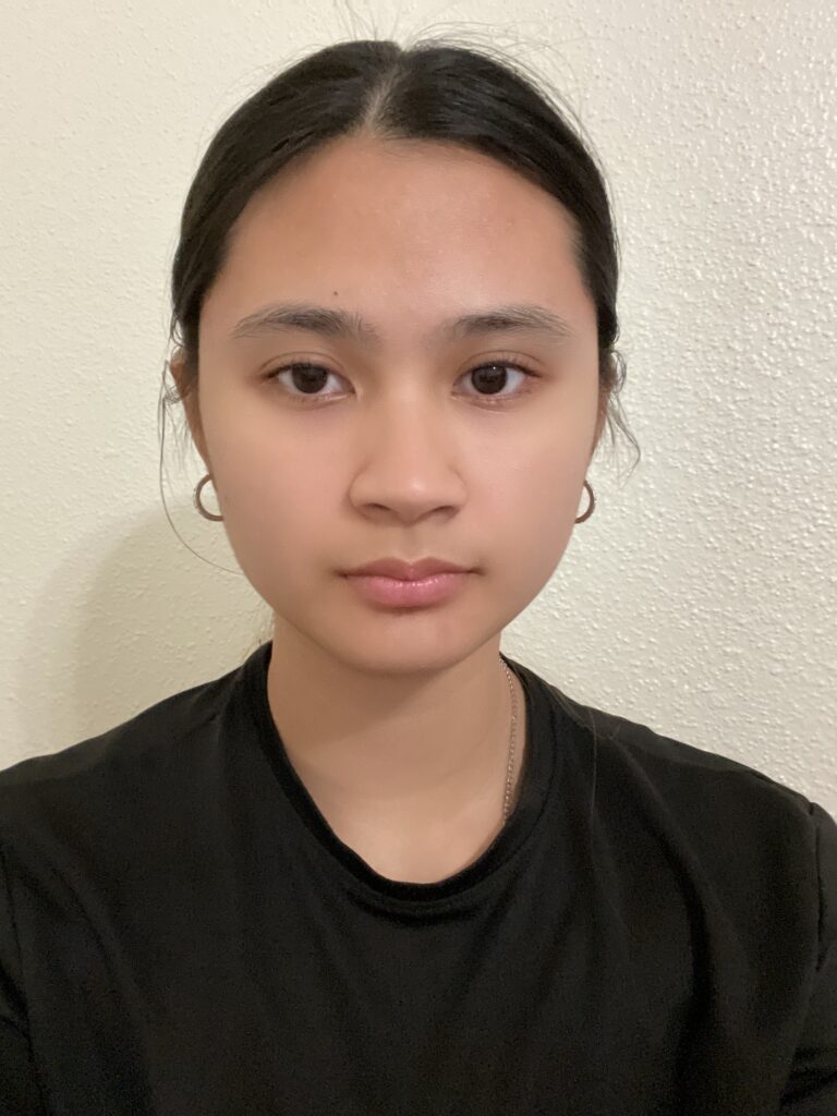 A girl wearing black and standing with a white background