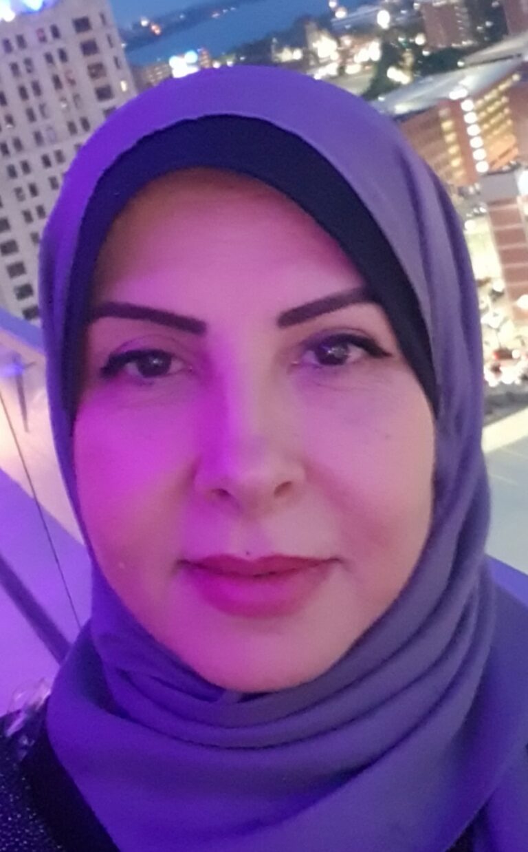 A woman taking a selfie while on the balcony of a building.