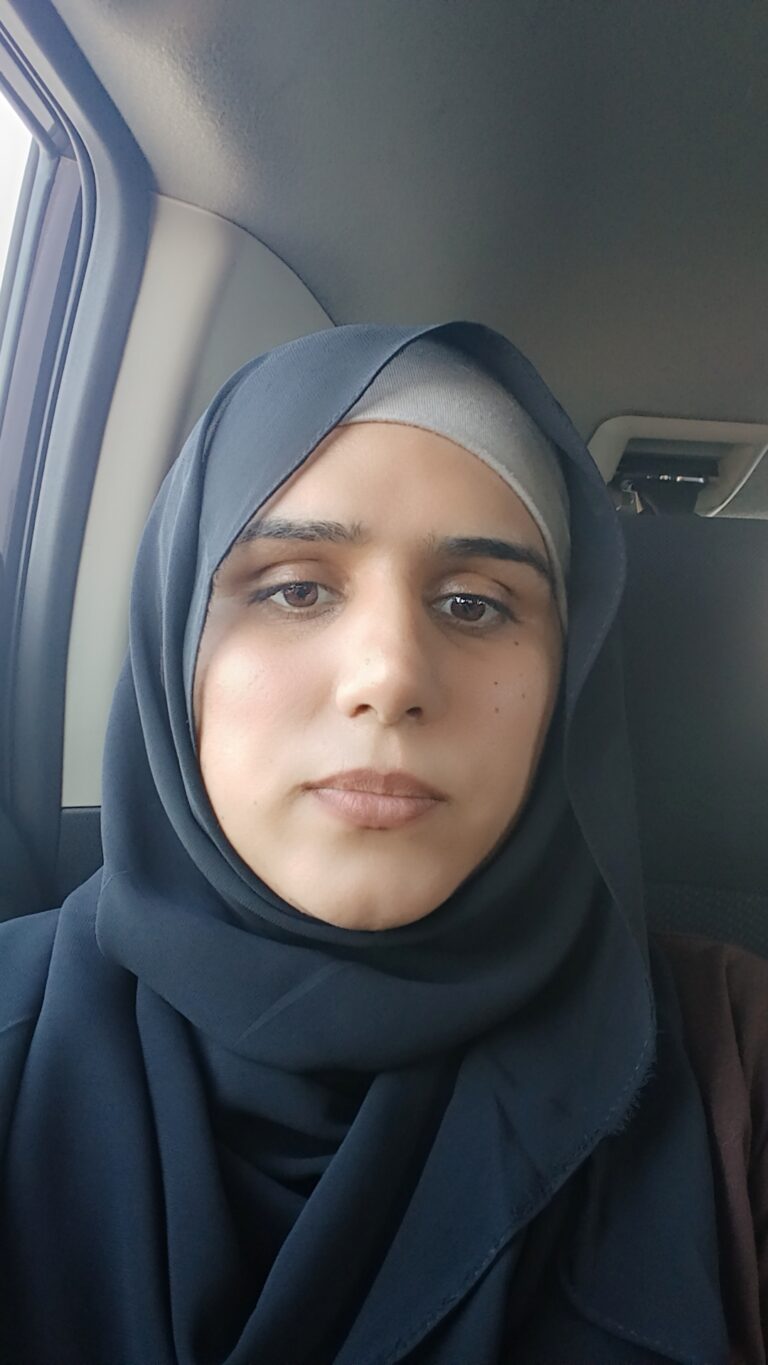 Woman wearing hijab in car seat.