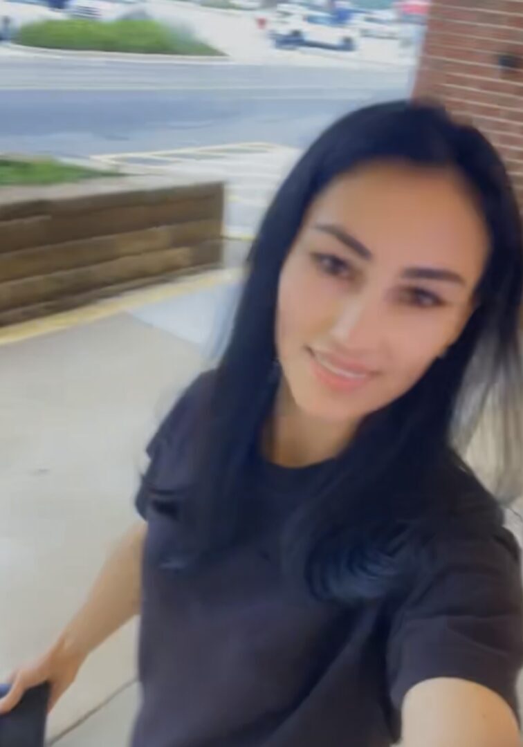 A Woman In A Black Color Top