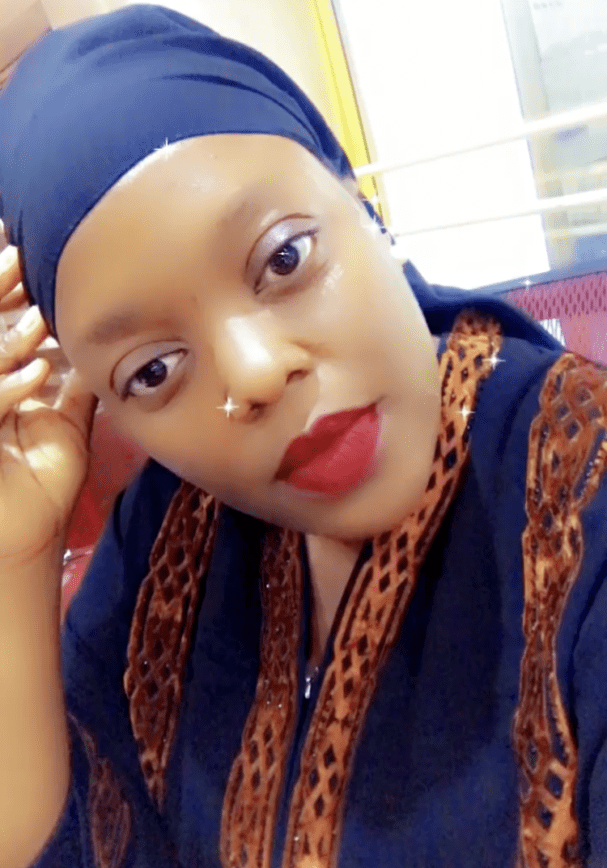Woman in headscarf with patterned attire.