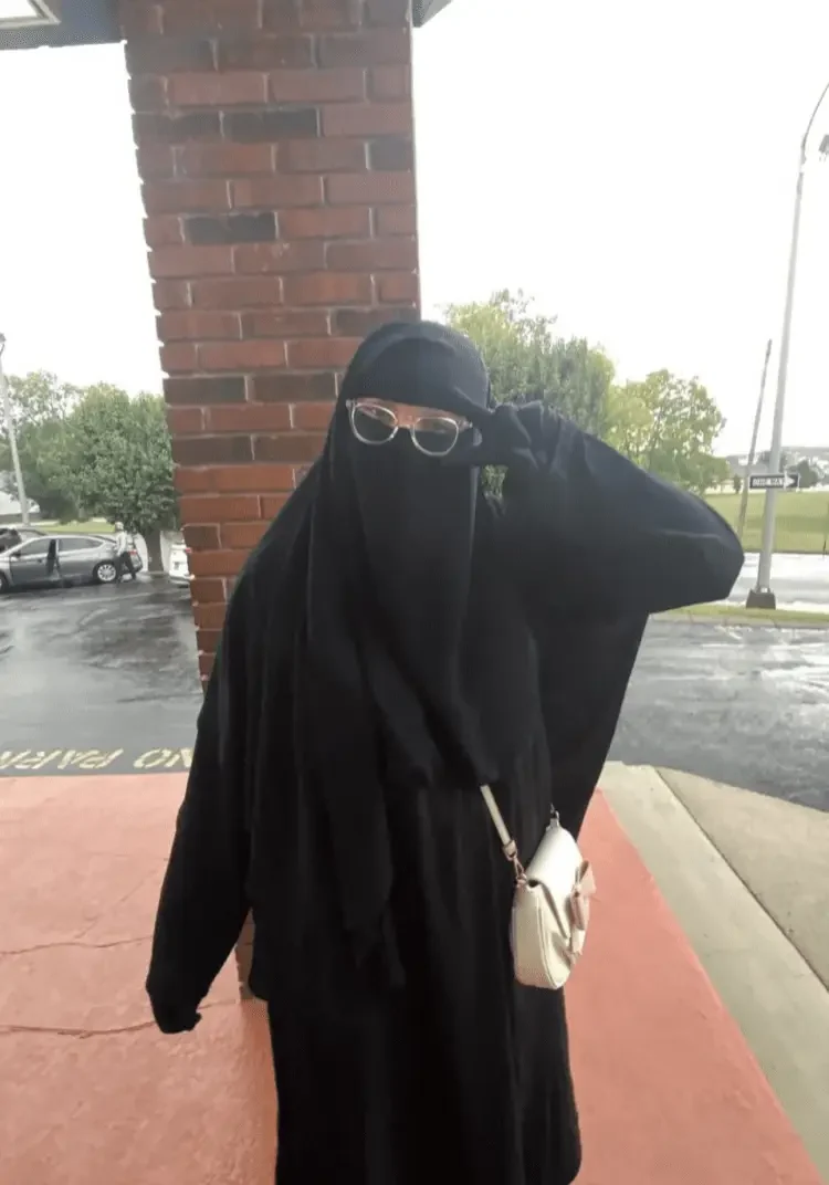 A Woman In A Burka And Glasses